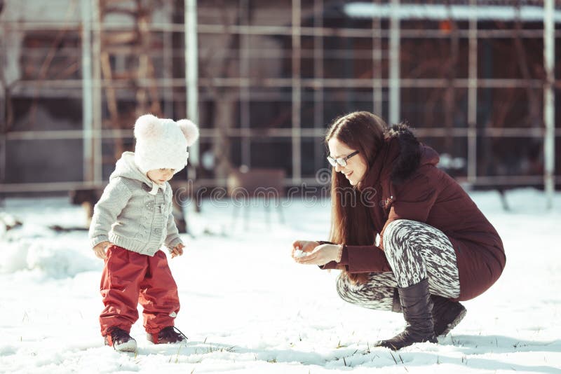 Mamã e bebê de passeio do inverno imagem de stock Mamã e bebê de passeio do inverno imagem de stock