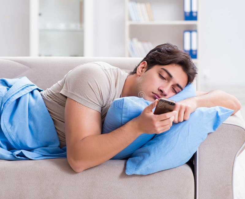 Man Addicted To His Mobile Phone In Bed Stock Photo
