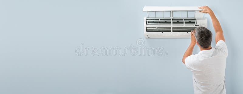 Man Adjusting Air Conditioning System