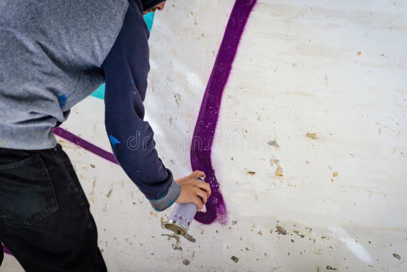 Man with aerosol paint to paint a graffiti stock photo
