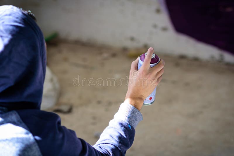Man with aerosol paint to paint a graffiti royalty free stock photography