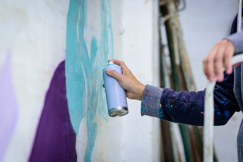 Man with aerosol paint to paint a graffiti stock photos