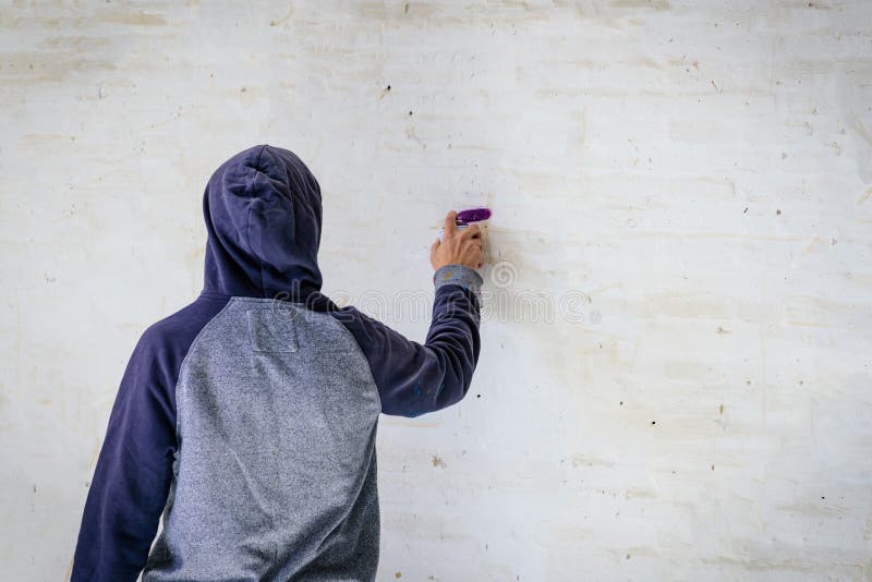 Man with aerosol paint to paint a graffiti royalty free stock images