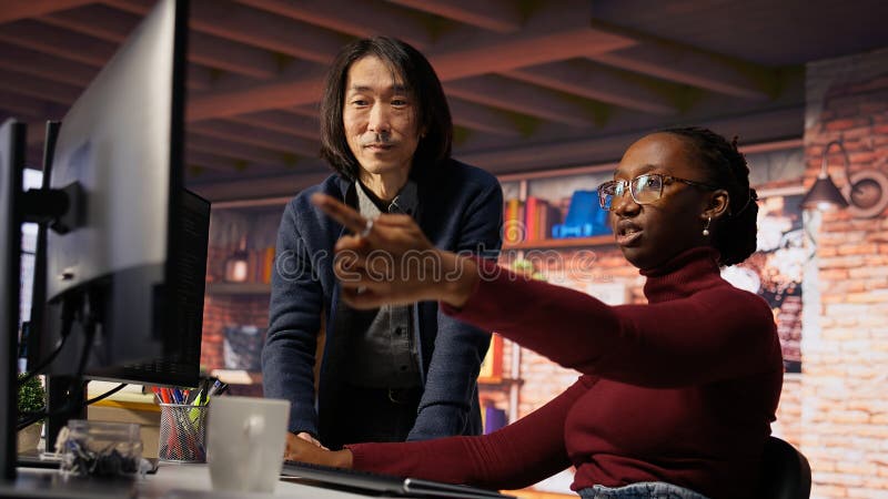 Man in AI startup office CTO position overseeing software engineer coding royalty free stock photo