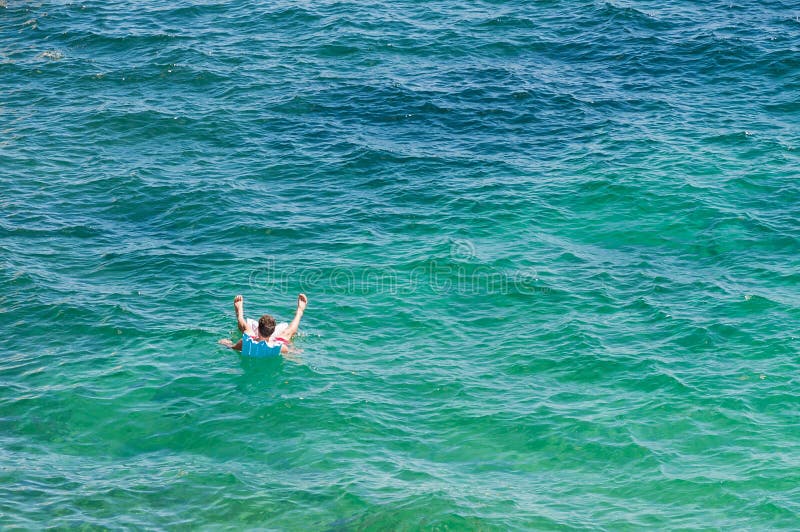Man on an Air Mattress in the Middle of the Water. Stock Image Image