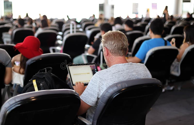 Man at the airport using his notebook computer while waiting for the flight.