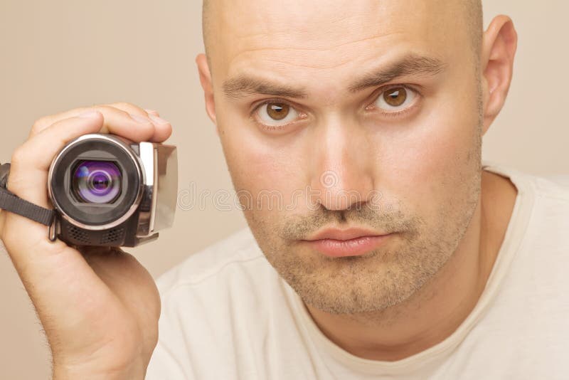 Man with amateur digital videocamera stock images