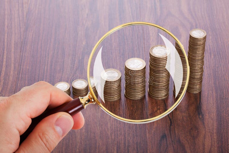 Man Analyzing Coin Stacks with Magnifying Glass Stock Photo Image of