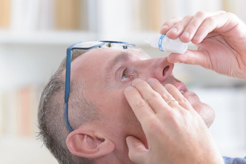 Man applying eye drops royalty free stock photos Man applying eye drops royalty free stock photos