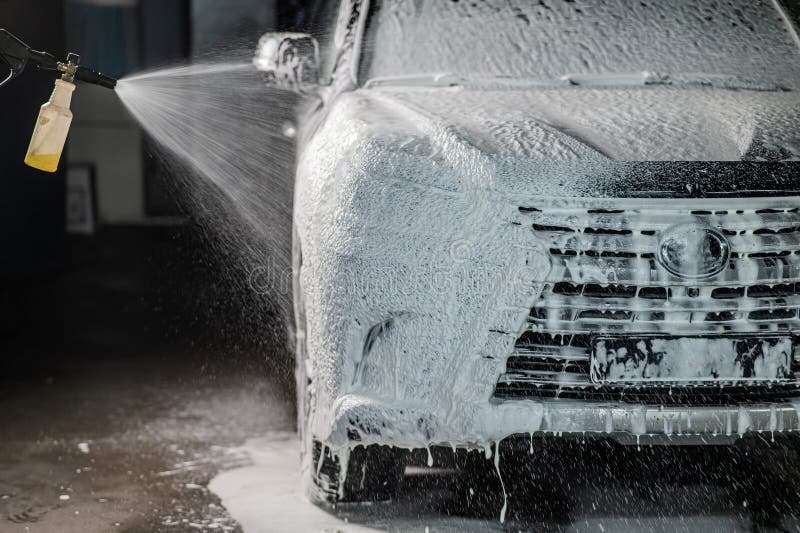 Man Applying Foam To Black Car in Car Wash. Stock Image Image of