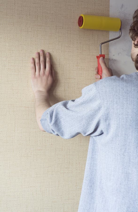 Man Applying Wallpaper To Wall Stock Image Image 4257831