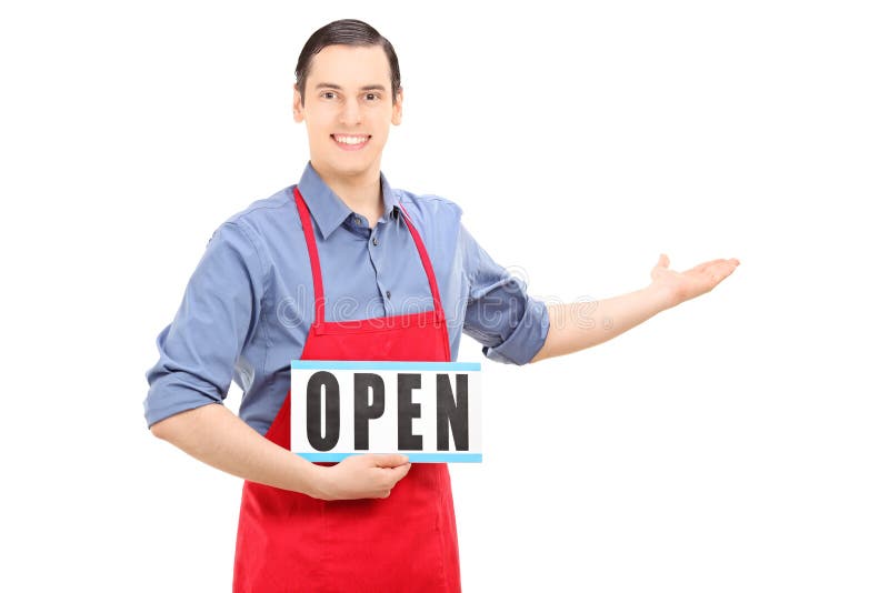 Man with apron holding an open sign stock photography