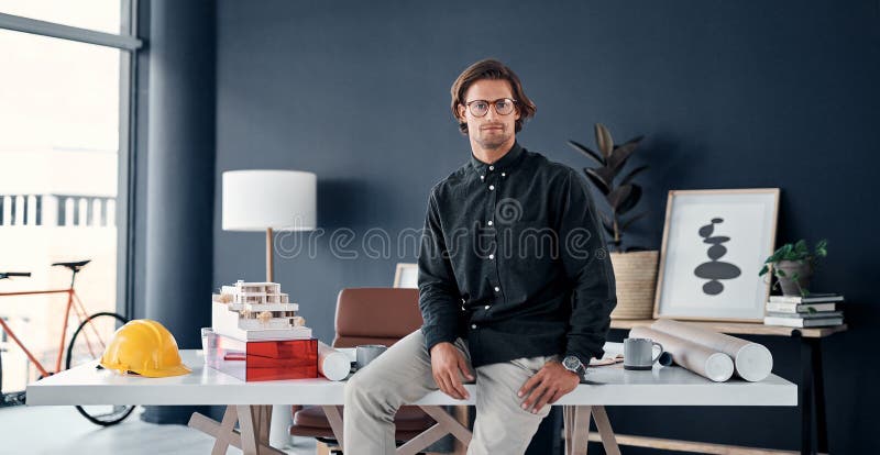 Man, architect and serious in portrait at desk in office, professional contractor and pride in career. Civil engineering stock photo