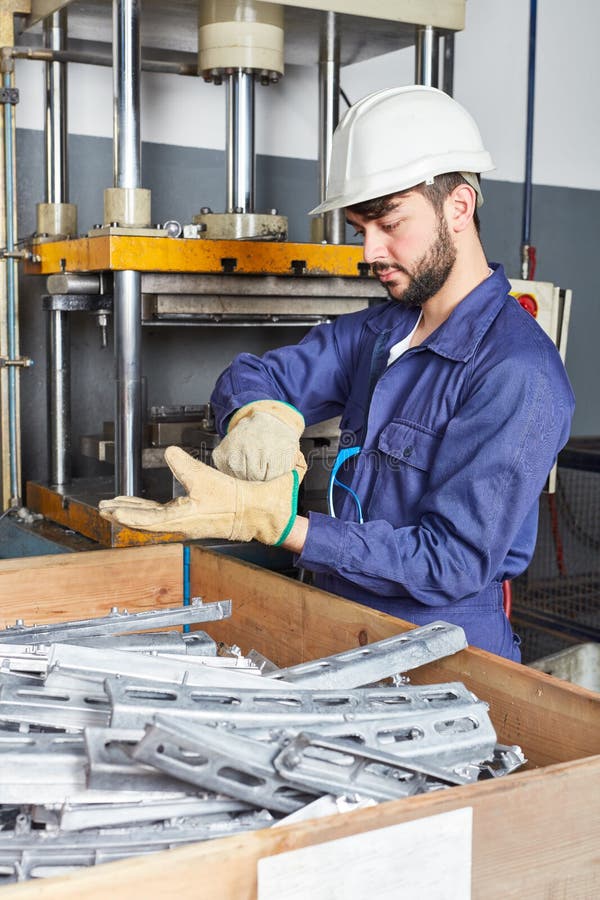 Worker in Metalworking Plant Installing a Rivets into Part for