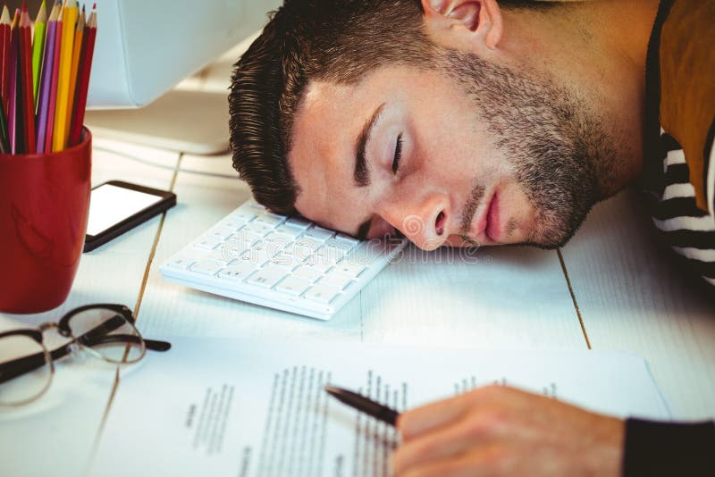 Man asleep at his desk in his office