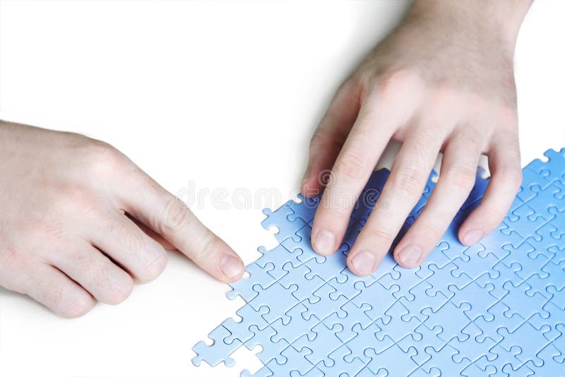 Man assembling blue puzzle