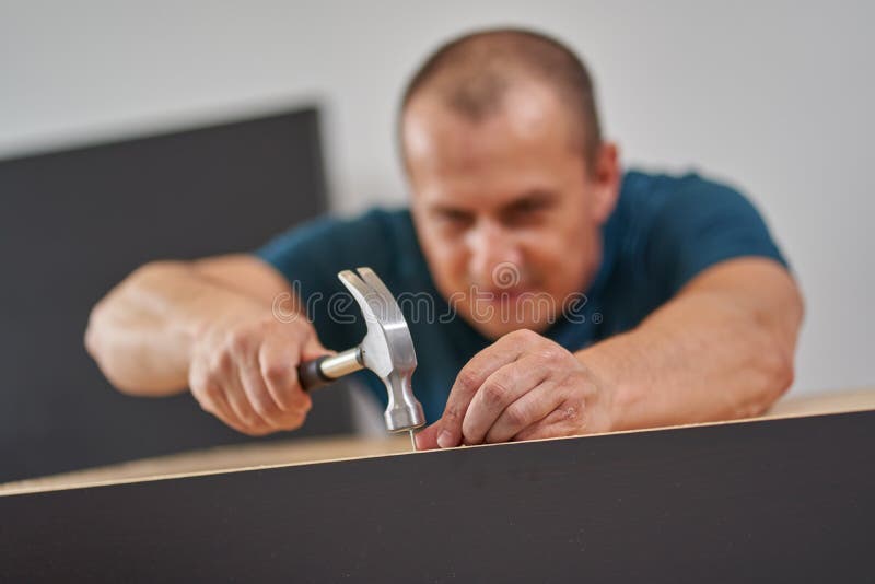 Man Assembling His New Furniture Stock Photo Image of construction, furniture 196498128
