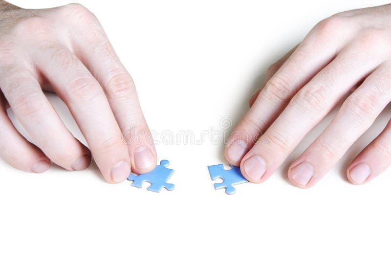 Man assembling two blue puzzle pieces