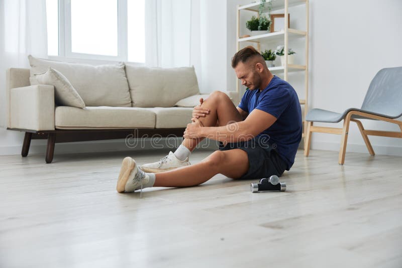 Man athlete pain and injury back arm and leg at home, sports injury bodybuilder, concept health and beauty. Man exercised stock images, royalty-free photos and pictures