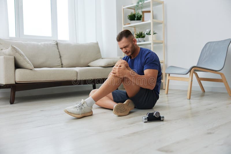 Man athlete pain and injury back arm and leg at home, sports injury bodybuilder, concept health and beauty. Man exercised stock images, royalty-free photos and pictures