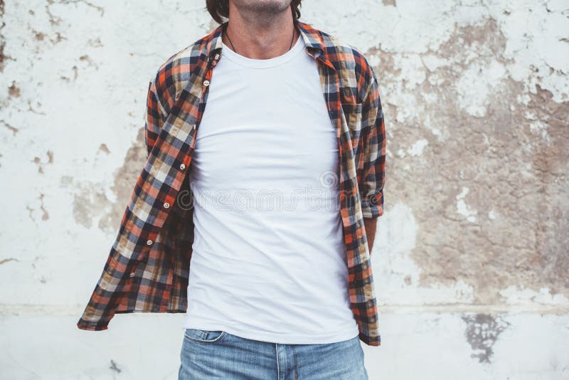 Handsome man wearing blank tshirt posing against street wall, front t shirt mock up on model, fashion urban style. Handsome man wearing blank tshirt posing against street wall, front t shirt mock up on model, fashion urban style