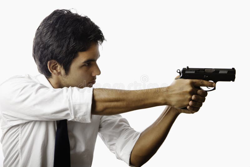 Young asian man with automatic pistol aiming at his target