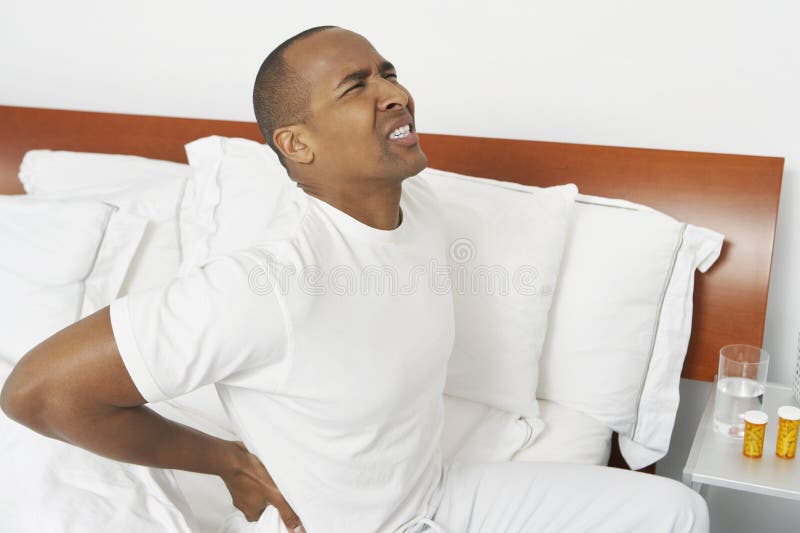 Man With Backache In Bed