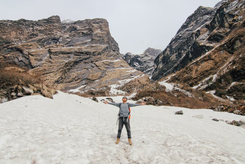 Man with backpack trekking in mountains. Cold weather, snow on hills. Winter hiking. royalty free stock photos Man with backpack trekking in mountains. Cold weather, snow on hills. Winter hiking. royalty free stock photos