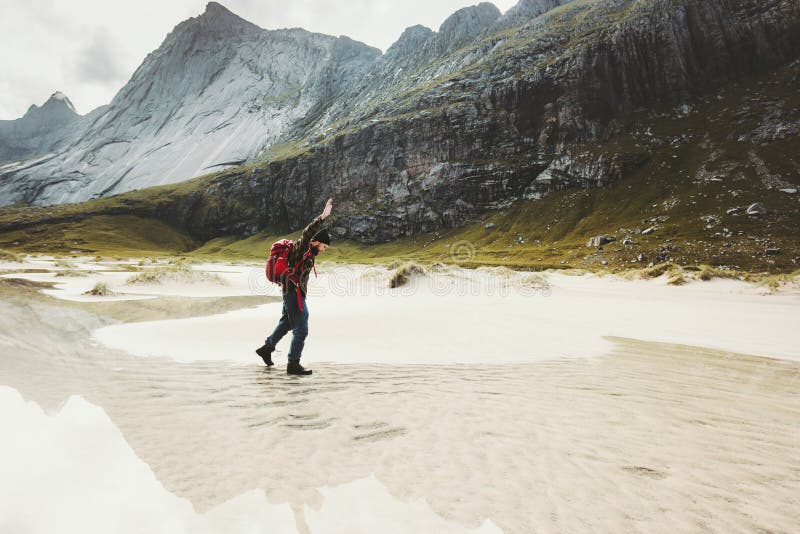 Man with backpack walking alone at sandy beach stock photography Man with backpack walking alone at sandy beach stock photography