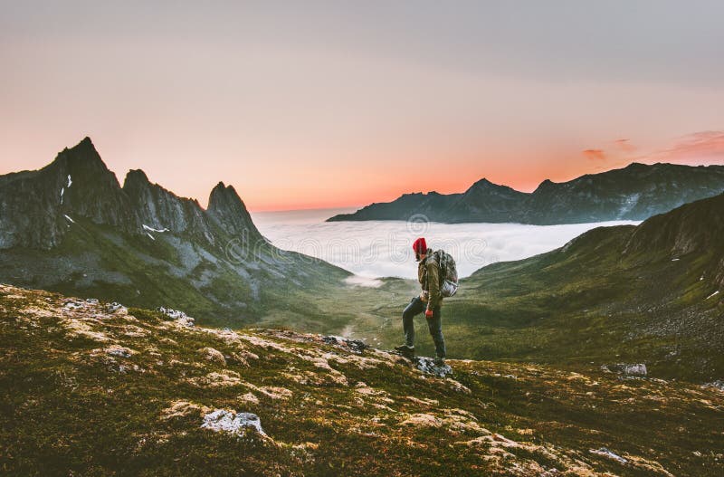 Man backpacker hiking in mountains alone outdoor