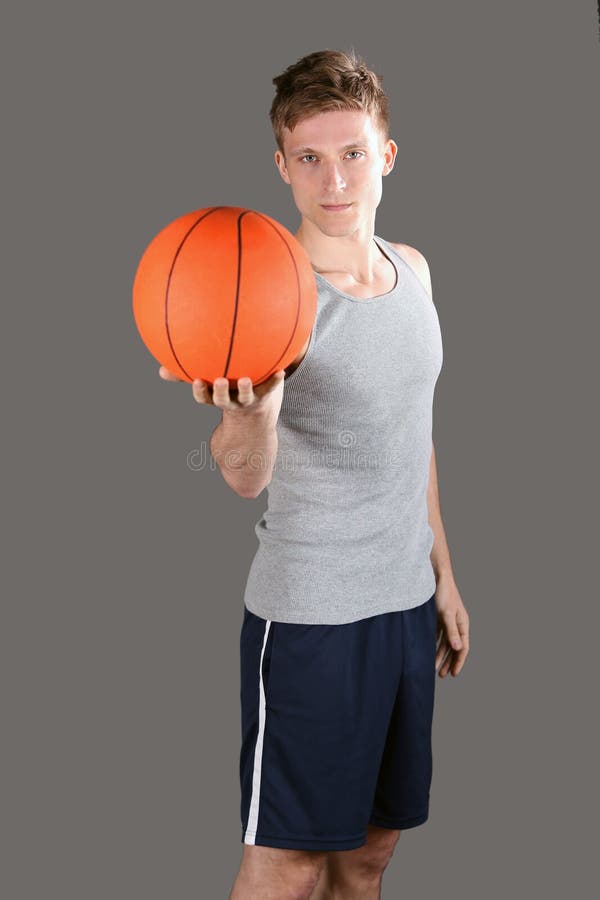 Young man holding a basketball. Young man holding a basketball