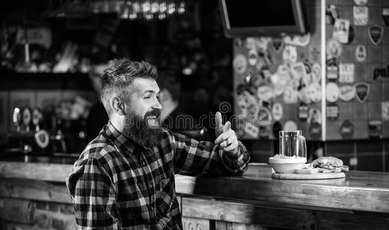 Man with Beard Drink Beer Eat Burger Menu. Enjoy Meal in Pub. High ...