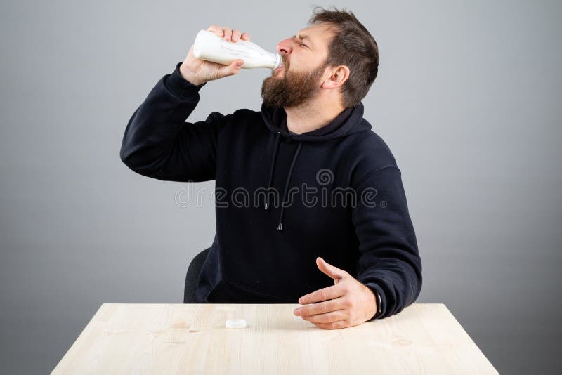 A Man with a Beard Eagerly Drinks a Milk Drink Stock Photo Image of