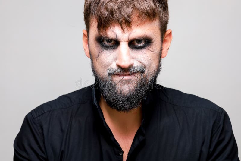 A Man with a Beard and a Menacing Look with Undead-style Makeup on All ...