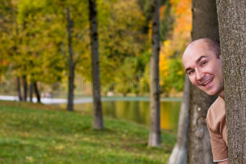 Man behind tree