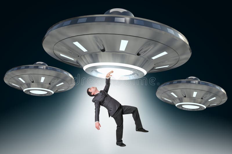 Man being abducted by UFO - concept of alien abduction. Man being abducted by UFO - concept of alien abduction