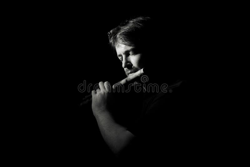 Man in black plays a flute