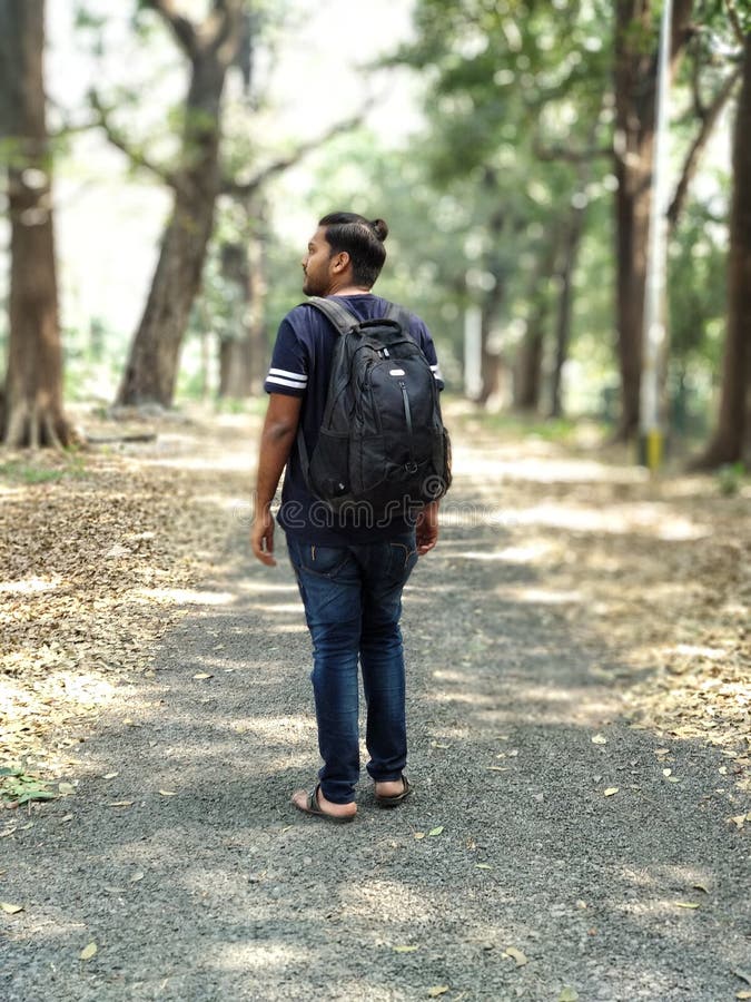 Man In Black And White T-shirt And Blue Denim Jeans Carrying Backpack Free Public Domain Cc0 Image