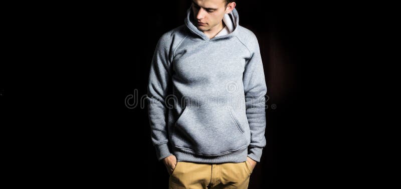 Man in the blank grey hoodie, sweatshirt on a black background, mock up, free space. Man in the blank grey hoodie, sweatshirt on a black background, mock up royalty free stock photos Man in the blank grey hoodie, sweatshirt on a black background, mock up, free space. Man in the blank grey hoodie, sweatshirt on a black background, mock up royalty free stock photos