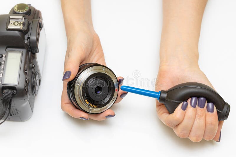 A Man Blows Dust Off a Camera Lens with a Pear Stock Image Image of