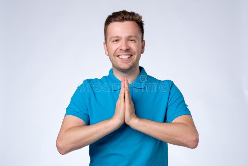 Man in Blue Shirt Holding Hands in Namaste Welcoming Guests Stock Image ...