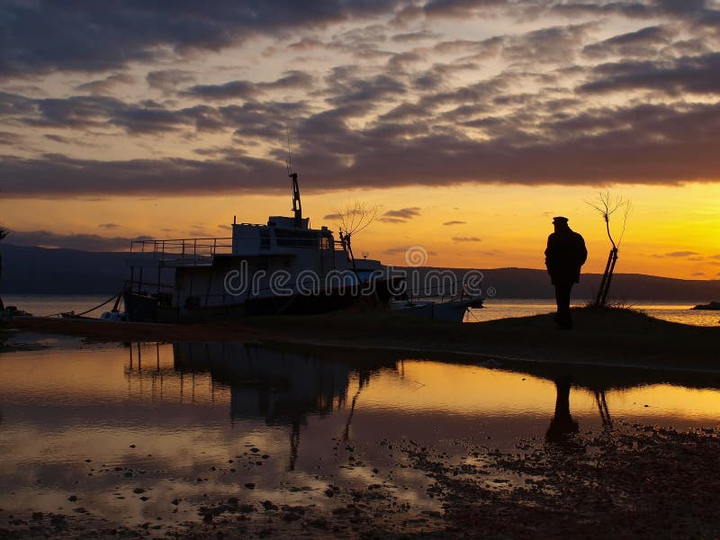 Man and a boats in sunset