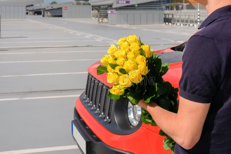 Man with a Bouquet of Flowers in a Car Parking Stock Photo Image of