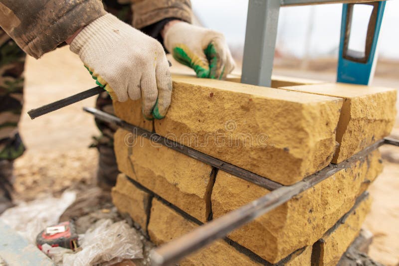 Man Builds a Brick Wall at a Construction Site Stock Photo Image of architecture, equipment