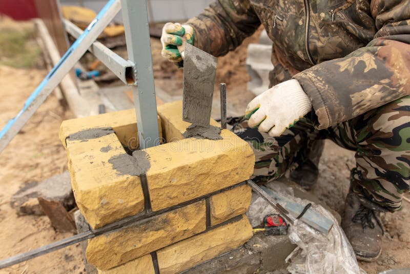 Man Builds a Brick Wall at a Construction Site Stock Image Image of mortar, bricks 138731963