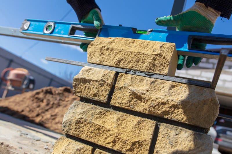 Man Builds a Brick Wall at a Construction Site Stock Photo Image of concrete, skill 138834612