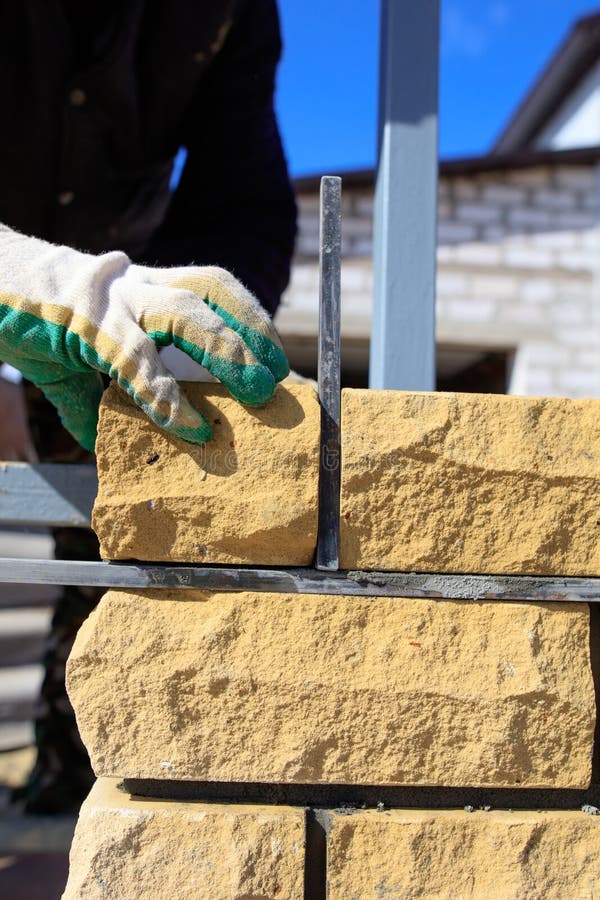 Man Builds A Brick Wall At A Construction Site Stock Image Image of skill, installing 138837943