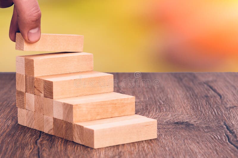 Man builds a wooden ladder. Concept: stable development royalty free stock photography Man builds a wooden ladder. Concept: stable development royalty free stock photography