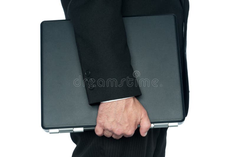A man in a business suit carrying a notebook