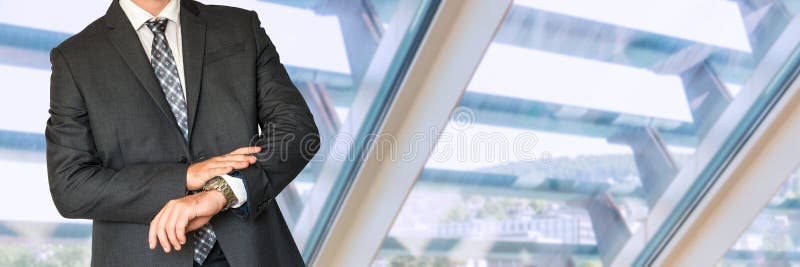 Man in business suit looking at hand watch stock photography Man in business suit looking at hand watch stock photography